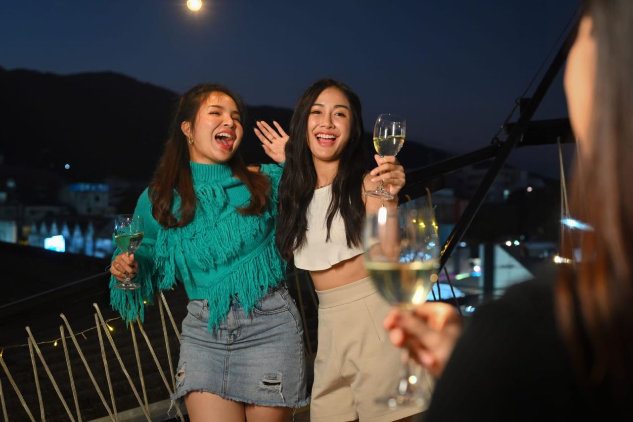 Cultural Integration and Social Life in Switzerland: female friends drinking happy